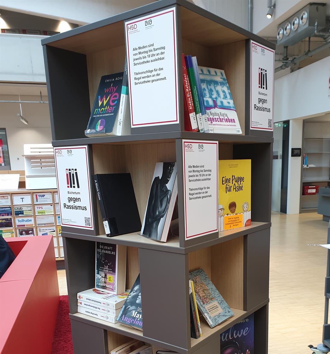 There is a bookshelf filled with different books related to the toppic racism.